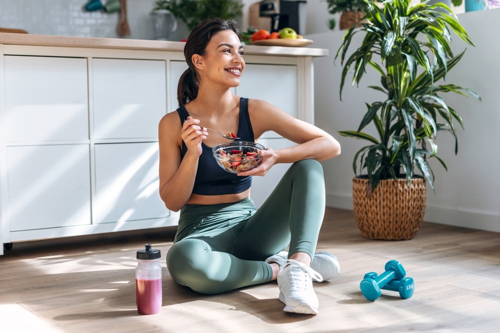 Athletic woman eating a healthy bowl