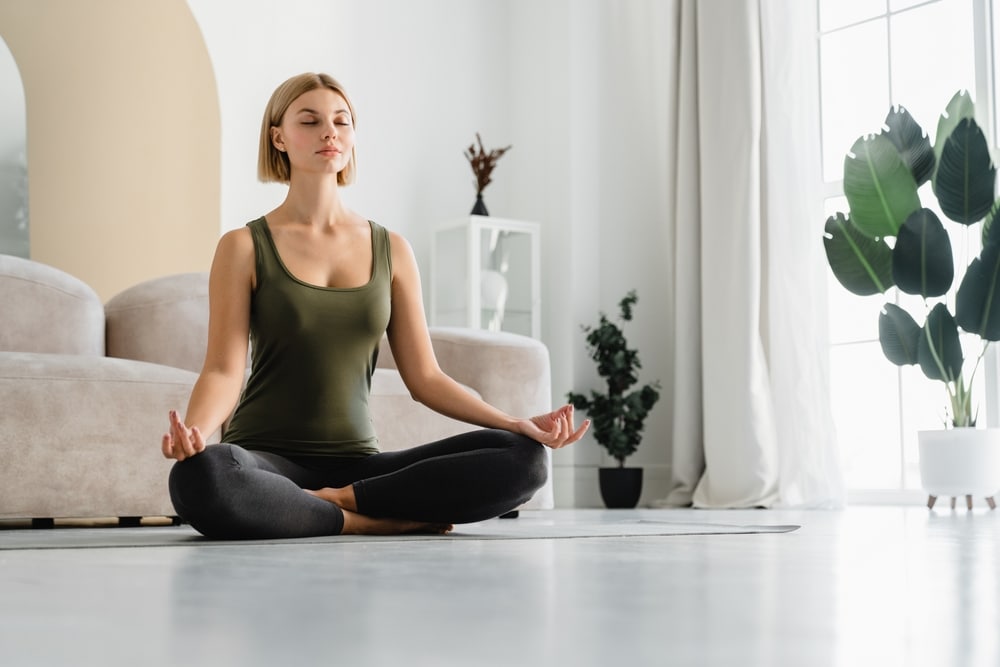 Female athlete sitting in lotus position meditating